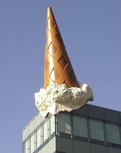 This giant ice-cream cone looks like it might have been dropped by an oversized child roaming the city of Cologne like a modern-day King Kong, but it is in fact the work of American pop artist Claes Oldenburg and his wife and frequent creative collaborator Coosje van Bruggen. The duo were commissioned to create this whimsical work by the German shopping mall upon which it appears to have landed. Pop Art Sculpture, Artist Of The Month, Claes Oldenburg, Food Sculpture, Artist Research, Oldenburg, Roadside Attractions, Wow Art, Gcse Art