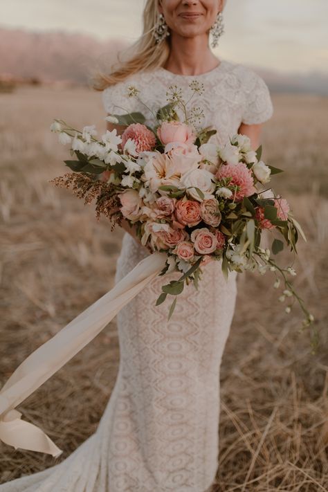 This lush bridal bouquet features pastel pink + white blooms for a romantic feel | Image by Dearheart Photos Elegant Boho Wedding Bouquet, Pink Boho Bridal Bouquet, Pastel Boho Wedding Decor, Wedding Bouquets Fairytale, Fairytale Bridal Bouquet, Pastel Pink Bridal Bouquet, Pale Pink Bridal Bouquet, Western Pink Wedding, Pink Wedding Bouquet Ideas