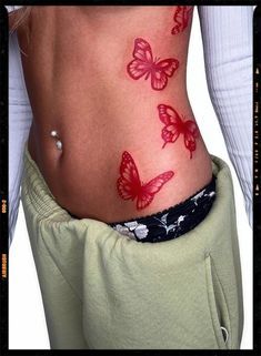 Tattoo Ideas Red Butterfly, Red Butterfly Tattoo Stomach, Red Butterfly Hip Tattoo, Red Butterfly Spine Tattoo, Red Butterfly Back Tattoo, Y2k Style Tattoo, Red Ink Thigh Tattoos Women, Red Rib Tattoos For Women, Thigh Tattoos Women Red Ink