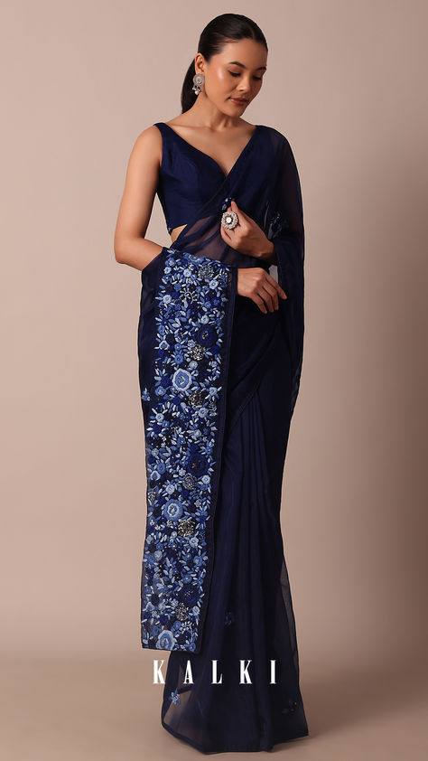 Embrace the allure of festivities in our exquisite Navy Blue Organza Saree. It is adorned with 3D flower bud embroidered floral buttis all over and a resplendent pallu. This ethereal ensemble promises a graceful and enchanting presence. The pack includes one saree and an unstitched blouse fabric for personalised styling. Navy Blue Saree Blouse, Bud Embroidery, Blue Organza Saree, Navy Blue Saree, Blue Organza, Silk Route, Iconic Dresses, Blue Saree, Organza Saree