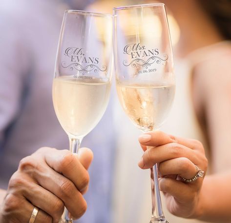 PRICES MAY VARY. Celebrate your special day with this pair of personalized engraved champagne flutes that perfect for your special occasion. Whether you're looking for an elegant touch for your wedding day or a unique gift for loved ones, etched flutes are a timeless choice that anyone will love. With their delicate stems and crystal-clear glass, our personalized flutes are the perfect addition to any wedding or celebration. Each flute can be customized with the names of the bride and groom, alo New Years Champagne, Bride And Groom Champagne Glasses, Bride And Groom Champagne, Engraved Champagne Flutes, Custom Engagement Gifts, Bridal Shower Gifts For Bride, Ringing In The New Year, Toasting Glasses, Wedding Champagne