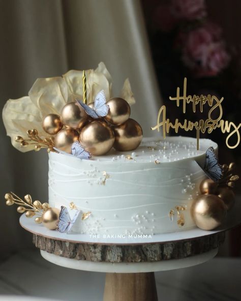 Celebrate your special moments with a touch of gold! This stunning anniversary cake, adorned with metallic spheres, delicate butterflies, and gold accents, is the perfect blend of elegance and sweetness. Whether it's for an anniversary, birthday, or any special occasion, let us craft a custom cake just for you! Ready to order? Message me on WhatsApp at 7044955912 and let's make your event unforgettable! #TheBakingMumma #AnniversaryCake #ElegantCakes #GoldAccents #CustomCakes #HomeBaker #Or... Elegant Anniversary Cakes, Attitude Video, Elegant Cakes, Custom Cake, Anniversary Cake, Touch Of Gold, Special Moments, Custom Cakes, Cake Designs