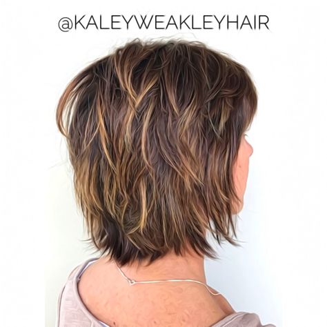 Those not keen on voluminous stacked bobs should try shags. Short textured hair replaces the height at the crown of the head with a uniform shaggy length. Incorporating shorter layers achieves the sought-after ragged appearance. Pro tip—highlighting them with blonde balayage gives extra definition! Two Layer Haircut Short, Short Textured Haircuts For Thick Hair, Shaggy Medium Bob For Fine Hair, Textured Bob Haircut With Bangs, Low Maintenance Hairstyles For Fine Hair, Hair Styles Fine Hair Over 50, Feathered Bob With Bangs, Med Shag Hairstyles, Edgy Shag Haircut