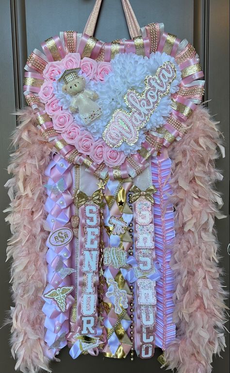 Mum Homecoming Senior, Wrestling Homecoming Mum, Senior Hoco Mums White And Gold, Senior Mums Homecoming White And Purple, Mums Homecoming Junior Year, Senior Hoco Mums Pink, Pink And Gold Mums Homecoming, Pink And Gold Homecoming Mum, Hoco Mums Ideas Senior