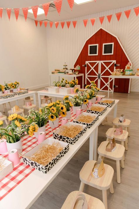 This birthday party exuded the farm theme to a tee. The blank raw space had a large red farm barn door installation, yellow sunflowers that lined each petite table and sweet treats in the shape of animals. The intricate details provided by Evoke Design and Creative made this party sensational, right down to the hay bale decor. Farm Baby Birthday, Hay Bale Decor, Barn Birthday Party, Farmyard Party, Farm Party Decorations, Animal Themed Birthday Party, Farm Themed Party, Barnyard Birthday Party, Barn Door Installation