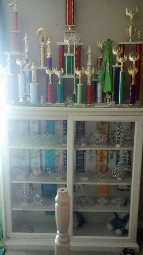 Displayed as a backing in a crown case. QueenOfGrits.com Sash Display Ideas, Crown And Sash Display, Shelves For Pageant Crowns, Trophy Case Aesthetic, How To Display Pageant Crowns And Sashes, Pageant Room, Dance Trophy Display Ideas, Pageant Awards, Pageant Crown Display Ideas