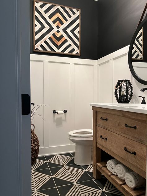 I must say this bathroom turned out amazing! I used a board and batten painted with Pure White by Sherwin Wiliams. The black color on the walls are Tricorn Black by Sherwin-Williams. This color combination paired with the black and white geometric tiles turned out to be stunning. Shop for tile by clicking the photo. Black Wainscoting Bathroom Wallpaper, Black Board And Batten Bathroom, Black Wainscoting Bathroom, Bathroom Wainscoting Ideas, Shower Redo, Navy Bathroom Decor, Black Wainscoting, Bathroom Downstairs, Bathroom 2024