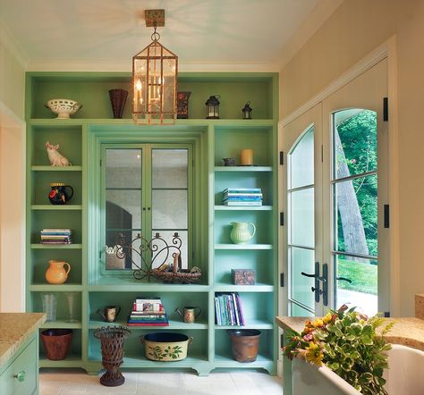 50 Chic Rooms with Green Accents. Color can bring an interior to life, especially when it comes to green. The bold hue is versatile enough to work as a wall color, upholstery fabric, or even a kitchen island. Ahead, see 50 stunning uses of green, from mint to a deep forest shade. Find your dream home at www.dongardner.com. #WeDesignDreams #DonGardnerArchitects Decorating With Shelves, Tv Shelf Unit, 1940s Office, Playroom Shelf, Decorate Hallway, Diy Bookshelves, Green Shelves, French Country Interiors, False Ceiling Bedroom