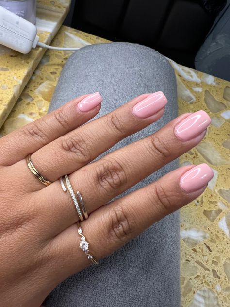 Hand with nails done in a light pink tone. Nails are square in shape and short. Short Square Glossy Nails, Chalk Pink Nails, Pink Aesthetic Nails Short, Nails Rounded Square, Light Pink Manicure, Rounded Square Nails, Natural Pink Nails, Dusty Pink Nails, Round Square Nails