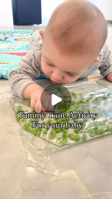 Farah Ghazale on Instagram: "Tummy time activity to try with your baby:  Baby’s age: 4 months  I grabbed a ziplock bag and removed label with nail polish remover. I put some peas in the bag and water then I sealed the bag with tape on the floor.  Put your baby on their tummy and have them explore. Tummy time is very important because it strengthens the muscles of their neck strengthening the muscles used to move their bodies so they can learn to roll, sit and crawl.  Note: never leave baby unattended.  #baby #babyactivities #tummytime #sensory #sensoryplay #sensoryplayideas" Tummy Time Water Mat Diy, Montessori Tummy Time, Tummy Time Ideas, Baby Games 0-3, Tummy Time Activities 3 Months, Tummy Time Newborn, Newborn Activities, Baby Tummy Time, Tummy Time Activities