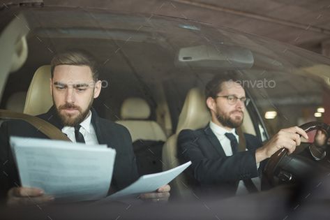 Businessman and driver in the car by AnnaStills. Young serious businessman reading a contract while his driver driving the car #Sponsored #car, #AnnaStills, #Businessman, #driver Business Contract, Car Side View, Car Poses, Inside Car, Car Sit, Person Sitting, Character Inspo, People Sitting, People Laughing