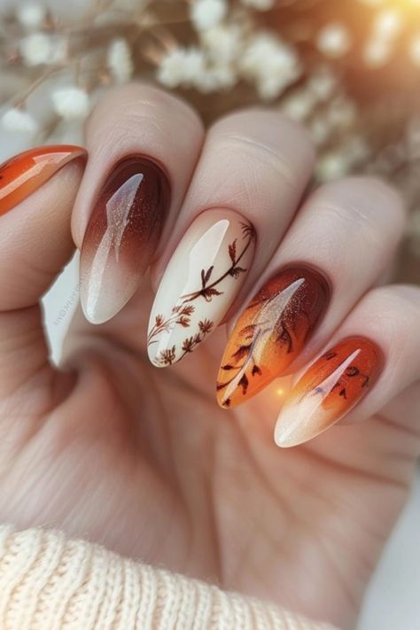 Autumn-themed manicure with gradient shades and leaf designs. Nails Fade Color, October Birthday Nail Ideas, Ombre Fall Nail Colors, Water Colour Nail Design, Autumn Almond Nails Design, Maroon And Orange Nails, Thanksgiving Ombre Nails, Ombre Autumn Nails, Orange And Purple Nail Designs