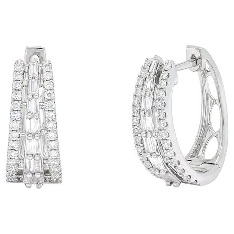 Elevate your style with sophistication and grace wearing these exquisite hoop earrings, adorned with brilliant baguette and shimmering round-cut diamonds set in gleaming 18 KT White Gold. Totaling 0.74 carats, the diamonds in these designer hoops are meticulously arranged to catch the light from every angle, creating a dazzling display of elegance. The combination of baguette and round-cut diamonds adds a unique texture and sparkle to these earrings, making them a standout accessory for any special occasion. Whether given as a thoughtful gift or worn to complement a special outfit, these hoop earrings are a symbol of refined luxury and timeless style. Their versatile design ensures they can be effortlessly paired with both formal and casual ensembles, adding a touch of glamour to any look. Belgian Modern, White Gold Hoops, Earrings Making, Color Dorado, Gold Hoop, Round Cut Diamond, Huggies Earrings, Elegant Gift, San Valentino