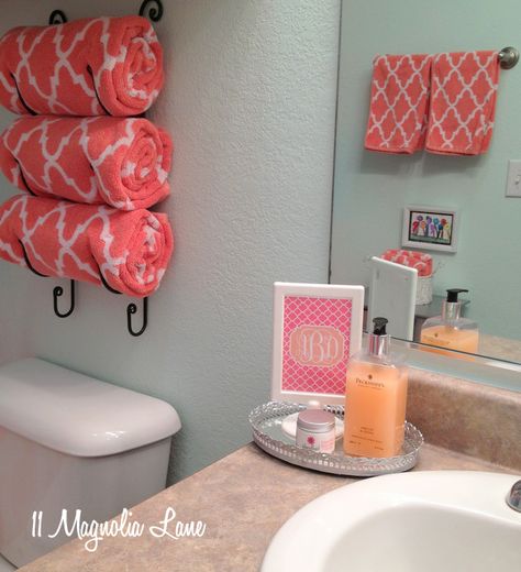 aqua coral bathroom - and I'm thinking of adding some framed vintage pictures or old vogue magazines to the wall. Perfect. Wine Rack For Towels, Coral Bathroom Decor, Coral Bathroom, Bathroom Organization Hacks, Apartment Decoration, Small Bathroom Storage, Girls Bathroom, Bathroom Organization, My New Room