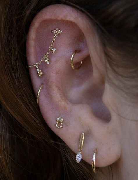 Earring Stacks Both Ears, Dainty Ear Styling, Dainty Gold Piercings, Earring Curation Gold, Gold Earring Curation, Interesting Ear Piercings, Gold Earscapes, Mixed Metal Ear Piercings, Ear Piercing Stacking Ideas