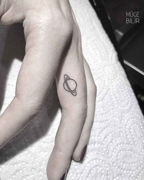 Planet Tattoos Minimalist, Ideas For First Tattoo For Women, Saturn Finger Tattoo, Saturn Tattoo Ideas, Small Saturn Tattoo, Saturn Tattoo Minimalist, Cute Alien Tattoo, Planet Tattoo, Middle Finger Tattoos