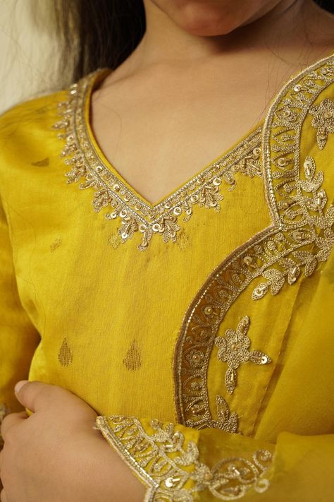 Lime yellow lehenga skirt featuring drop pattern highlighted with lace and aari embroidered borders. Comes with matching aari embroidered blouse and scalloped hem embroidered dupatta. Components: 3 Pattern: Embroidered Type Of Work: Aari Neckline: V-neck Sleeve Type: Half Fabric: Chanderi Handloom: 50% Silk X 50% Cotton, Lining: Shantoon Color: Yellow Other Details:  Blouse back closure Lehenga side tasselled drawstring Back cut-out neck with tassels Attached lining Note: Outfit worn by boy chil V Neck Kurti Design, Embellished Lehenga, Yellow Kurti, Yellow Lehenga, Embroidery On Kurtis, Lime Yellow, Scalloped Border, Kurti Embroidery Design, Drops Patterns