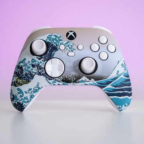 About The design on this Xbox controller is a Japanese piece named “The Great Wave off Kanagawa”. You may have seen it before but didn’t know it’s name ;) Since it’s creation, almost two hundred years ago, it has been interpreted in so many different ways. FOR US, that’s precisely the beauty of having it on the quintessential controller:Customizing your controllers is about self expression and interpretation of what your gaming experience is for YOU. Seeing “The Great Wave” on a Sony controller Custom Game Controller, Custom Xbox Controller, Custom Xbox One Controller, Control Xbox, Custom Controller, Custom Xbox, Dark Vibes, Xbox Wireless Controller, Xbox Accessories