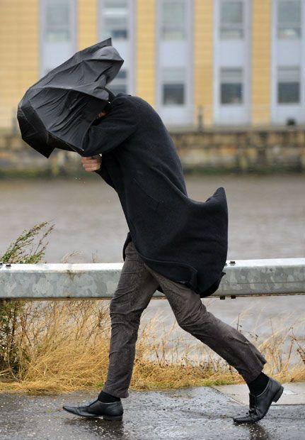 An office worker struggles with an umbrella in storm coming People In The Rain, Standing In Rain, People With Umbrellas, Sunshine On Leith, Wind Painting, Leith Edinburgh, Blowin' In The Wind, Autumn Weather, Zine Design