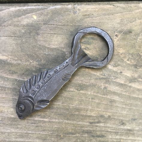 This whimsical and unique bottle opener was hand forged from mild steel. It is as functional as it is handsome. NOTE:  These items are handmade and natural variations will occur.  This item is made to order, and will ship within 6-8 weeks (although sometimes sooner).  Send me a message to inquire about rush orders. No cancellations, returns or exchanges as these items are made to order. Forged Metal Projects, Fantasy Style Hand Forged Jewelry As Gift, Artistic Hand Forged Jewelry Gift, Welded Bottle Openers, Blacksmith Letter Opener, Forged Letter Opener, Forging Hammer, Forged Bottle Opener, Hand Forged Bottle Opener