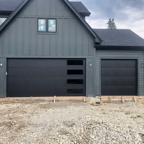 Skyline Flush Garage Door, Black Garage Doors Green House, Black Garage Doors With Windows, Dark Garage Doors, Dark Grey House Exterior, Stacked Windows, Cabin Paint Colors, Grey Garage Doors, Brown Garage Door