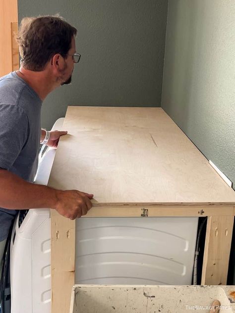 Frame In Washer And Dryer, Laundry Room Hinged Counter, Wood Over Laundry Machine, Laundry Counter Over Washer And Dryer, Diy Base For Washer And Dryer, Diy Open Cabinets Laundry Rooms, Laundry Cabinets Diy, Counter Top Over Washer And Dryer, Garage Laundry Makeover