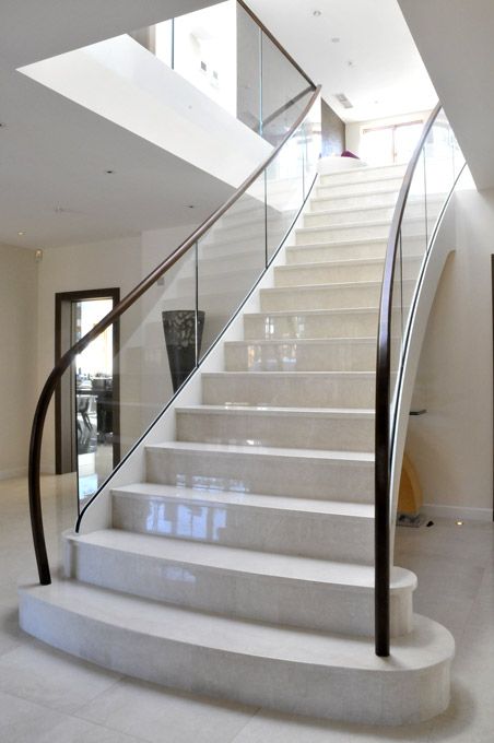 Modern contemporary staircase with curved glass balustrades - constructed from steel, glass, marble and hardwood american walnut handrail. Modern Contemporary Staircase, Stairs Lights, Chettinad House, Luxury Stairs, Luxury Staircase, White Staircase, Contemporary Staircase, Stairs Ideas, Marble Stairs