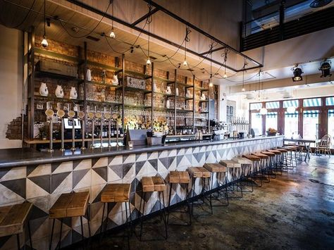 The long bar counter is clad in black and white geometric pattered tiles, paired with bar stools made from tubular black steel and wooden planks.  John Salt Bar in London Bar In Casa, Bar Design Awards, Bar Inspiration, London Bars, Bar Interior, Bar Design Restaurant, Restaurant Interior Design, Tap Room, Hospitality Design