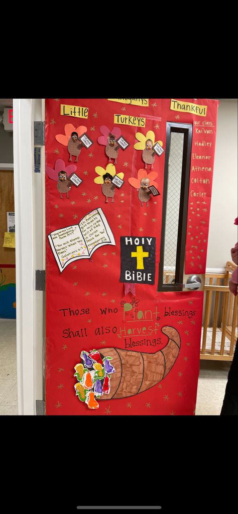 A different take on a thanksgiving themed door with the childrens faces cut out and made into turkeys holding signs that say “eat mor chicken” . At the bottom I made fruits and vegetables out of their foot prints and placed them it into a cornucopia that I made out of a white poster that i then colored and cut out . In the middle portion of the door I made a Bible that I put common thanksgiving scriptures in. Lastly to fill in the blank space I took a gold metallic marker and drew  little stars Thanksgiving Toddler, Thanksgiving, Doors