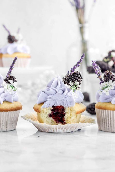 Welcoming in the Springtime with these delicious Vanilla Cupcakes with Blackberry Jam Filling and the sweetest Lavender Frosting! Every bite of is like a warm embrace of the sun...with sweet floral notes. Made with simple ingredients, the vanilla cupcakes are light, fluffy, and everything a perfect cupcake should be. Lightly sweet, hints of vanilla, and so simple to make...but the real stars of the show are the homemade blackberry jam and the super simple lavender frosting! The jam is… Blackberry Lavender Jam, Lavender Frosting, Blackberry Cupcakes, Homemade Blackberry Jam, Lavender Cupcakes, Cupcake Decorating Tips, Culinary Lavender, Filled Cupcakes, Blackberry Jam