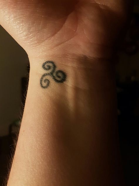 small 20p size celtic symbol left wrist 3 swirls meaning power of 3 ( religious) also celtic scottish/irish decent Tiny Celtic Tattoos, Celtic Grandmother Tattoo, Tiny Celtic Tattoos For Women, Dainty Irish Tattoo, Irish Simple Tattoos, Celtic Swirl Tattoo, Ireland Tattoos, Irish Symbol Tattoos, Irish Tattoos For Women