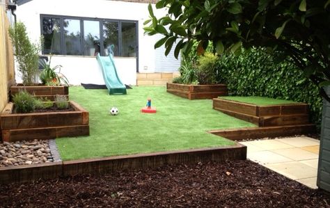 Family garden in Brighton, Sussex, with a large area of artificial grass for low maintenance. Raised timber planters for ornamental planting, vegetables and herbs and a raised sandpit Raised Grass Area, Kitchen Courtyard, Artificial Grass Ideas, Timber Planters, Garden Companion Planting, Brighton Sussex, Florida Landscaping, Garden Grass, Small Garden Ideas