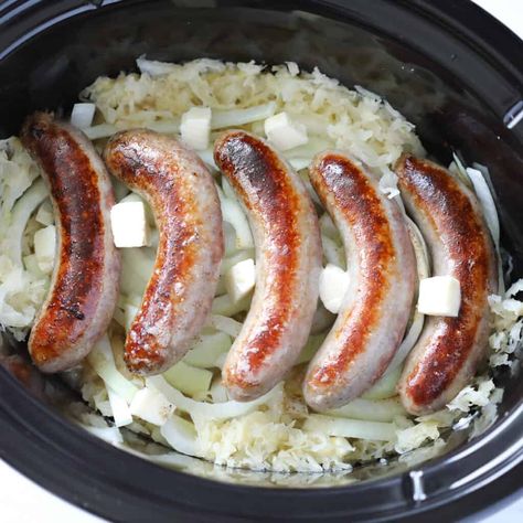 laying the crockpot brats on top of the sauerkraut and dotting with butter Slow Cooker Brats And Sauerkraut, Bratwurst And Sauerkraut Recipes Crockpot, Bratwurst And Sauerkraut Recipes, Brats In Crockpot, Brats And Sauerkraut, How To Cook Bratwurst, Whole Lotta Yum, How To Cook Brats, Brats Recipes