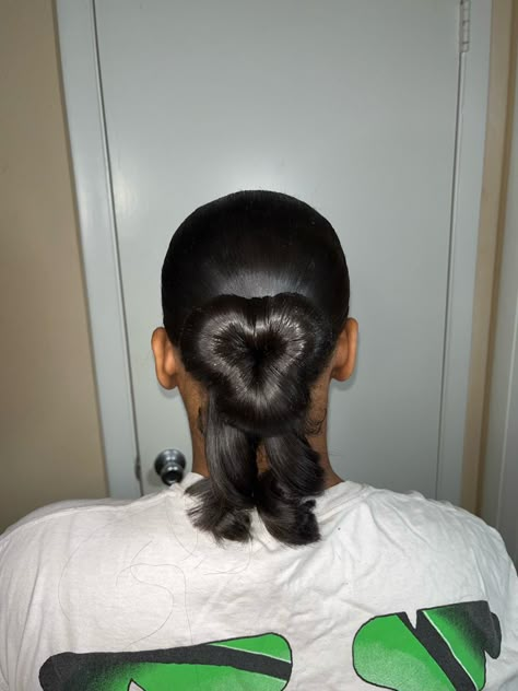 Sleek bun shaped like a heart Sleek Heart Bun, Heart Bun With Curls, Heart Swoop Bun, Heart Shaped Hairstyles For Black Women, Heart Shaped Slick Back Bun, Heart Bun Half Up Half Down, Heart Shaped Bun Hairstyles, Low Bun For Prom, Heart Bun Black Women