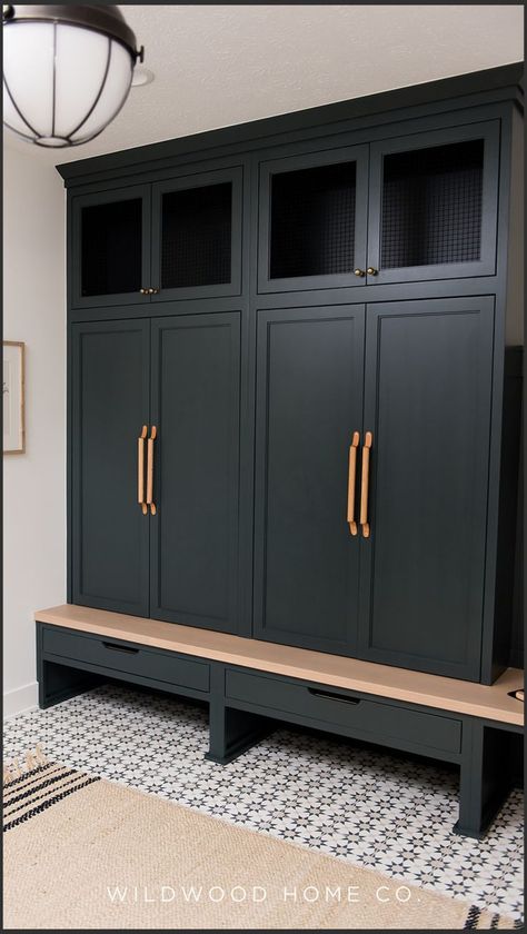 Tired of laundry day chaos? Wildwood Home Co. creates open laundry & mudroom spaces that are as beautiful as they are functional. This design features rich dark green cabinetry with copper hardware and streamilined drawers, that set off the crisp white walls; warm wood accents to tie it all together. Plus, stunning, easy-to-care-for floors! We specialize in incorporating our clients’ personalities into new construction & renovations. Visit wildwoodhomecompany.com to see our full service studio. Iron Ore Mudroom Lockers, Mudroom Drawers, Laundry Mudroom, Farmhouse Mudroom, Mudroom Cabinets, Copper Hardware, Floor Remodel, Residential Architect, Laundry Day