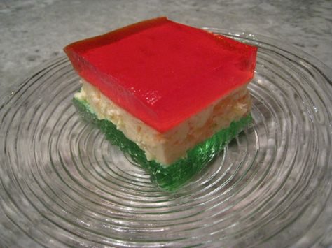 This red, white, and green jello is a classic addition to the holiday table (you can switch colors for other occasions). Recipe from Celebrating 100 years of Jello. I speed-up the chilling time table by setting each bowl/pan over a larger bowl/pan of ice water (lots of ice). I do this with all my Jello and each stage is done in about 15-20 minutes. You need to check for required texture and not go by clock. I love making these layered desserts! Jello Pudding Desserts, Ribbon Salad, Jello Recipe, Green Jello, Lemon Jello, Jello Desserts, Jello Salad, Layered Desserts, Jello Recipes