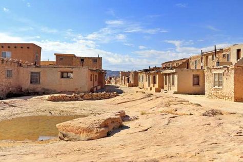 Acoma Pueblo, Albuquerque ~ Recent excavations suggest that this historic pueblo could have been inhabited even earlier than the date that currently earned the Acoma Pueblo a designation as the oldest continuously inhabited community in the US (1150 AD). Today nearly 50 Acoma tribe members continue to reside in “Sky City”—a name given to the site due to its perch on top of a 367-ft mesa—without running water, electricity, or cell service. Much like it would have been for the tribes’ ancestors. Acoma Pueblo, New Mexico History, Adobe Home, Taos Pueblo, Sky City, Living History Museum, Travel Facts, Visit Santa, Old Church