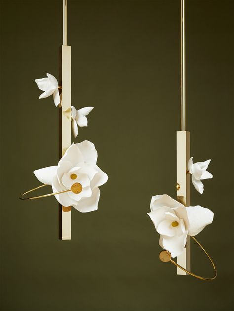 Each blossom—a unique, delicate arrangement. At once open and closed, the flower’s light and shadow lure one into its contemplative depths.  Lure Pendant 21 and 30, from PELLE, transforms a flower’s transient beauty into a lasting light. In this fixture, a cast paper flower is spot lit by a suspended LED light source. Held by a slender brass arc, the light shines brightly on a blossom built of hand-sculpted petals, displaying texture, structure, and delicacy Art Lighting, Bubble Chandelier, The Lure, Contemporary Lamps, Vintage Chandelier, Lamps Ceiling, Ceiling Lighting, Chandeliers And Pendants, Ceiling Pendant