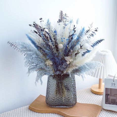 Blue Fake Flower Arrangements, Blue Pampas Arrangement, Blue Winter Centerpieces, Pompadour Grass Centerpiece, Blue Winter Wedding Centerpieces, Blue Pampas Grass Decor, Coastal Floral Arrangements, Pampas Grass Wedding Centerpieces, Blue And White Floral Arrangements