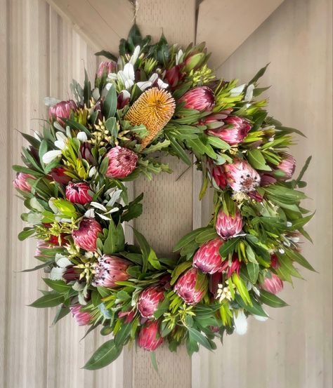 As wreaths go up, we love the idea of replacing the faux with fresh protea & greens. But what can you do to help ensure the longevity? Follow these steps: Water your Wreath: A wreath kept outside in a warm climate, or displayed indoors will need frequent watering or misting. Avoid Sunlight: Your wreath should be kept out of direct sunlight & away from heat. Enjoy: After the flowers begin to fade, cease misting and let the wreath dry naturally. Protea don’t die, they dry Beautifully. Protea Wreath, Heather Wreath, White Flower Farm, Protea Flower, All Season Wreath, Botanical Decor, Wreaths And Garlands, Welcome Fall, Handmade Wreaths