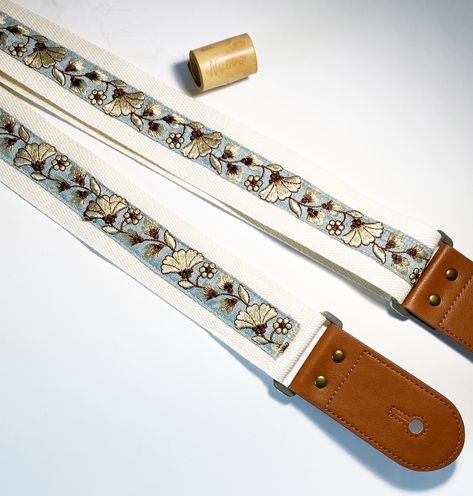 This is a unique and tasteful Guitar  strap. The face fabric is made from fine details embroidery trim.   It will be come with an end button for affixing on your musical instrument.  Also, a guitar pick will be offered and the color will be given by random.    Size: Main fabric Length: maximum approx. 125 cm  (embroidery design part: approx. 90 cm)  Main Strap Width: 5cm Leather Part: bar to hole 8cm (both sides)  Since they are handmade items, there may be a bit variation in measurement and the prints pattern on each piece. Also, I have already tried my best to take the photo as close to the real color as possible. But please understand that there may be color shade especially viewed from different screen.  The items are shipped from Hong Kong. The shipping time varies from countries. It Guitar Strap Aesthetic, Leather Guitar Strap Pattern, Leather Guitar Strap, Guitar Straps, Dad Gifts, Guitar Strap, Musical Instrument, Braided Leather, Guitar Pick