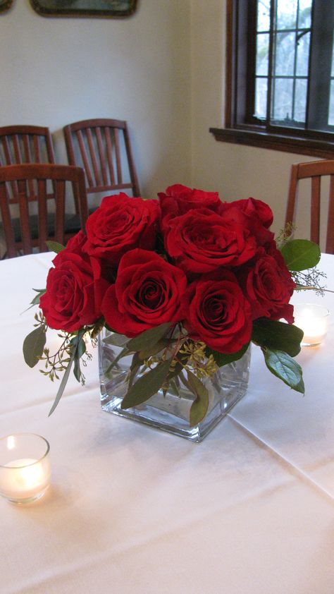 Simple and elegant red rose centerpiece Small Red Rose Centerpiece, Elegant Red Rose Centerpieces, Roses Centerpieces Quinceanera, Wedding Centerpieces Red Roses, Red And Green Centerpieces, Rose Centerpieces Simple, Red Flower Table Centerpieces, Rose Centerpieces Quinceanera, Red Roses Centerpieces Quinceanera