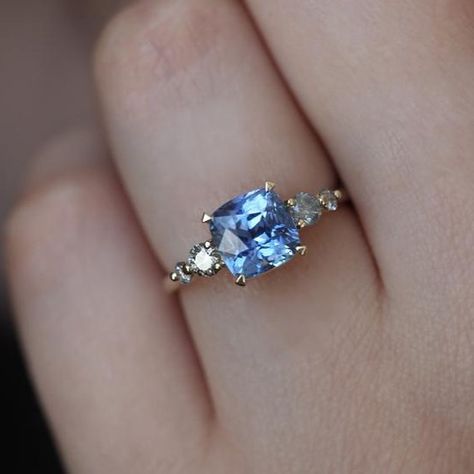 Cushion cut sapphires never looked better 💕  With salt and pepper diamonds on the side, our Simone ring is a stellar ring that will wow you in a heartbeat 💗 tap for details. Blue Sapphire Diamond Ring, Light Blue Sapphire, Diamond Sapphire Engagement Ring, Cushion Ring, Blue Sapphire Diamond, Sapphire Diamond Ring, Bling Rings, Blue Sapphire Rings, Salt And Pepper Diamond