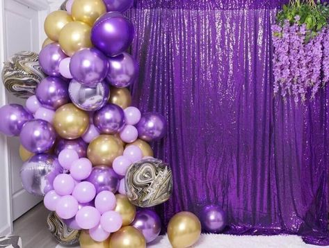 Create a dazzling birthday backdrop to bedazzle your invitees. Set purple sequin curtains on a backdrop stand for a captivating charm. Arrange purple, gold, and black marble balloons on one side of the backdrop to ooze exuberance. Furthermore, place lavender wisteria garlands on the other side to impart a lovely floral flair to the backdrop decor. Backdrop With Curtains, Event Decor Ideas, Marble Balloons, Sequin Curtains, Party Decorations Table, Backdrop Decor, Decorations Table, Party Backdrop, Backdrop Decorations