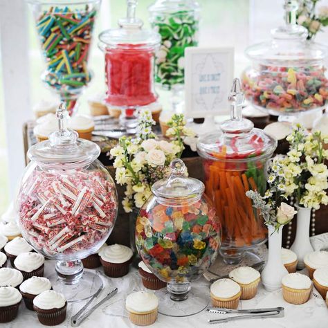 Turn your dessert table into an old-fashioned candy store by arranging your favorite goodies in vintage-inspired apothecary jars. Image: The Last Forty Percent Grad Party Candy Bar, Wedding Candy Bar Buffet, Vintage Wedding Candy Bar, Wedding Buffet Table Decor, Vintage Candy Bars, Wedding Buffet Table, Wedding Dessert Table Decor, Sweet Table Wedding, Reception Desserts