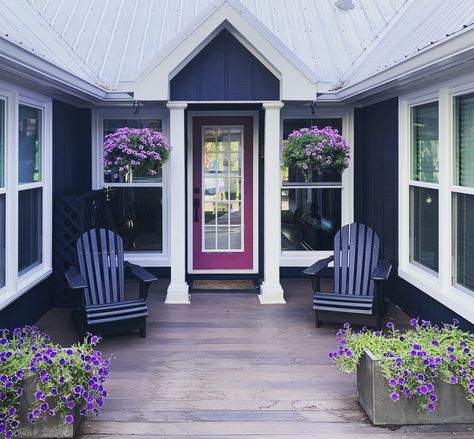 Classic blue and white exterior with a pop of color at the front door  Hale Navy exterior paint, Sea Pearl trim and Summer Plum front door all by Benjamin Moore.  I love my lake house ❤️💕 Blue House With Purple Door, Blue And Purple House Exterior, Blue House Purple Door, Plum House Exterior, Navy House Door Color, Purple Exterior House Colors, Blue Exterior Paint Colors For House, Blue House Door Color Ideas, Purple House Exterior