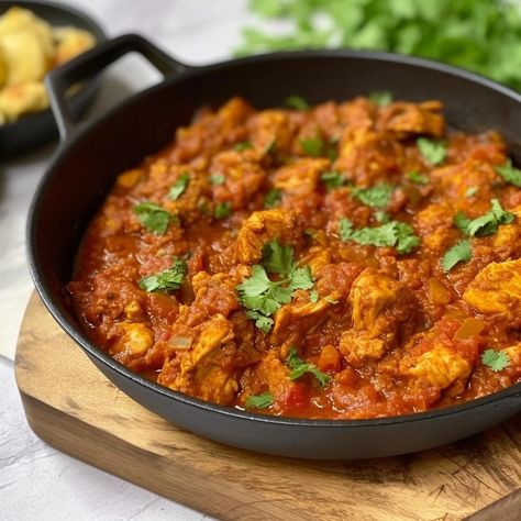 Chicken bhuna is a spicy and flavourful dish that is definitely worth trying for Indian cuisine lovers. A classic Indian chicken curry made with boneless chicken, onions, tomatoes, and an array of spices. ‘Bhuna’ is the term for fried. In this case, it refers to the chicken being cooked in the onion and tomato masala. […] The post Chicken Bhuna appeared first on Scrumptiously. Chicken Bhuna Recipe, Bhuna Chicken Recipe, Chicken Bhuna, Chicken Breast Curry, Chicken Madras, Easy Supper Recipes, Indian Chicken Curry, Chicken Recipes Video, Indian Chicken