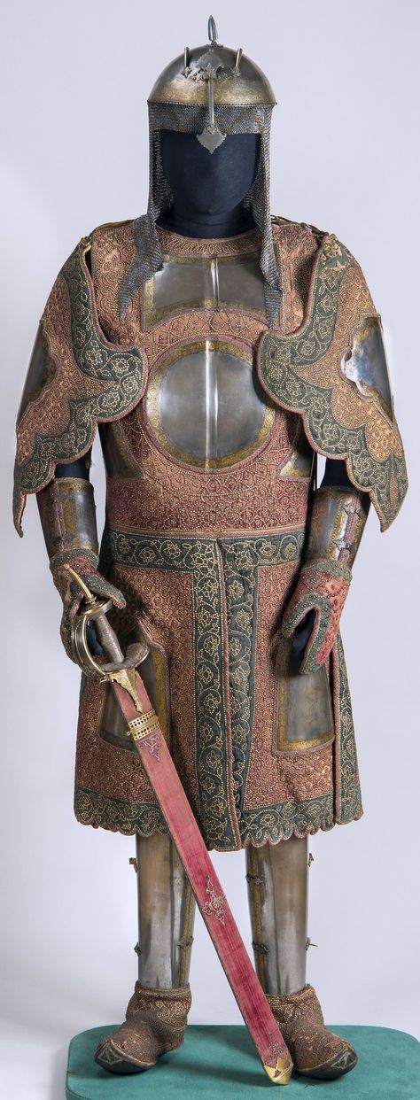 Chilta hazar masha (coat of a thousand nails), kulah khud (helmet), bazu band (arm guards). Indian armored clothing made from layers of fabric faced with velvet and studded with numerous small brass nails, which were often gilded. Fabric armor was very popular in India because metal became very hot under the Indian sun. This example has additional armor plates on the chest area, arms, and thighs. Hermitage Museum. Rajput Armor, Fabric Armor, Indian Sun, Brass Nails, Arm Guards, Armor Clothing, Ancient Armor, Historical Armor, Hermitage Museum