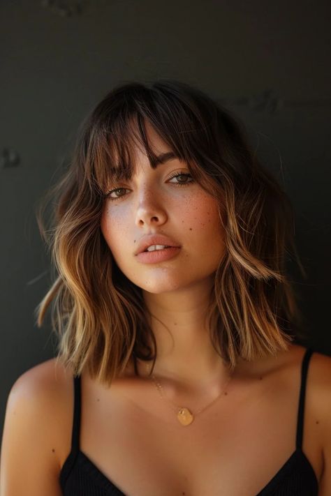 Woman with wavy brown hair and bangs, wearing a black top, against a dark background. Bangs Lob Haircut, Shoulder Length Hair With Layers Bangs, Bangs Lob, Cute Mom Haircuts, Hair With Long Bangs, Short Wavy Hairstyles For Women, Mom Haircut, Shoulder Length Hair With Bangs, Mom Haircuts