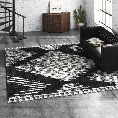 This geometric area rug grounds your space in neutral tones and linear design. It features a repeating diamond print against a textured background in black and white hues. Power-loomed from stain-resistant polypropylene using a shag technique, it has a high 1.5" pile height - making it a plush addition to low-traffic areas like your bedroom or home office. This rug is designed for indoor use only, and comes in a range of shapes and sizes to suit your design scheme. Rug Size: Rectangle 4' x 6' | Modern Black Area Rug, Black Modern Farmhouse Decor, Black Area Rug Bedroom, Black And White Area Rug Living Room, Black And Tan Rug, Black Boho Rug, Black And White Rugs, Western House, Black White Area Rug